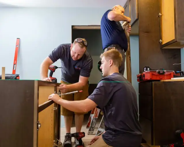 GMH Construction carpenters installing kitchen cabinets in a Waukesha County home